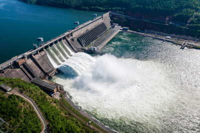 Hydroelectric dam on the river, water discharge from the reservoir, aerial photography