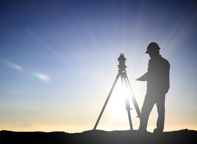 silhouette black man survey and civil engineer stand on ground working in a land building site