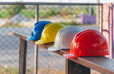 Construction hard hat safety tools equipment workers in construction site engineering protection head hang on wood wall.